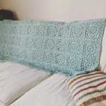 crochet blanket displayed on the back of a sofa.